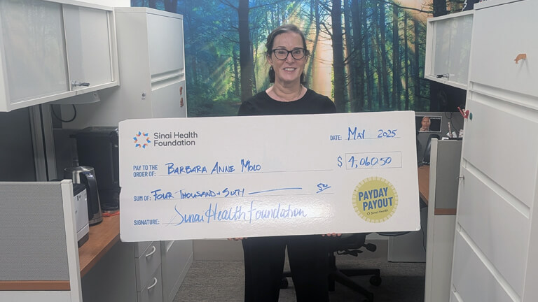 Photo of Barbara Anne Molo with Payday Payout cheque