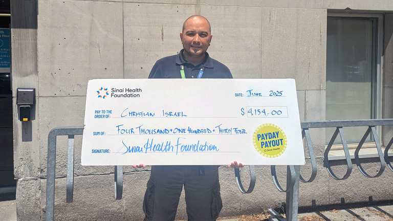 Photo of Ronaldo Palomo with Payday Payout cheque