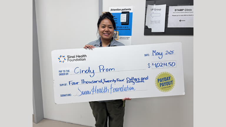 Photo of Cindy Prom with Payday Payout cheque