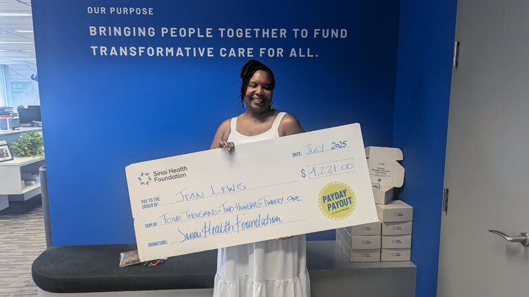 Jean Lewis, July 16 2025 Payday Payout winner holding cheque.