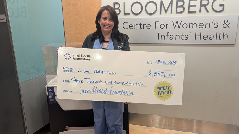 Photo of Lisa Hamilton with Payday Payout cheque