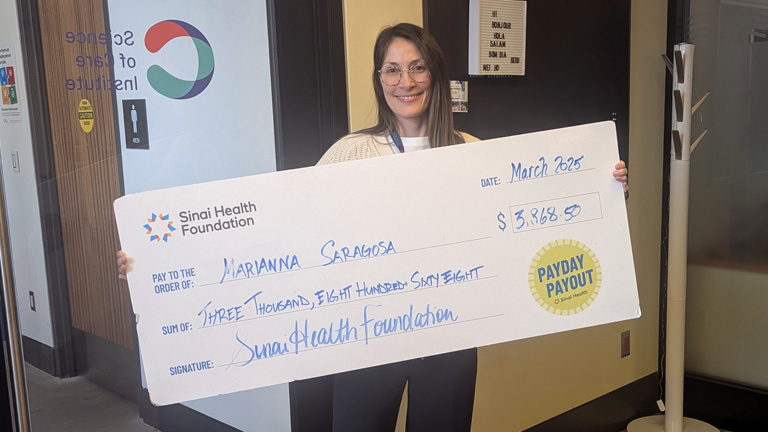 Photo of Marianne Saragoza with Payday Payout cheque