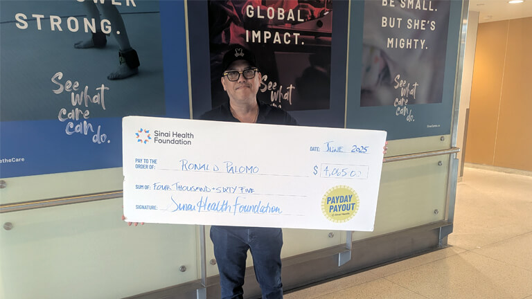 Photo of Ronaldo Palomo with Payday Payout cheque