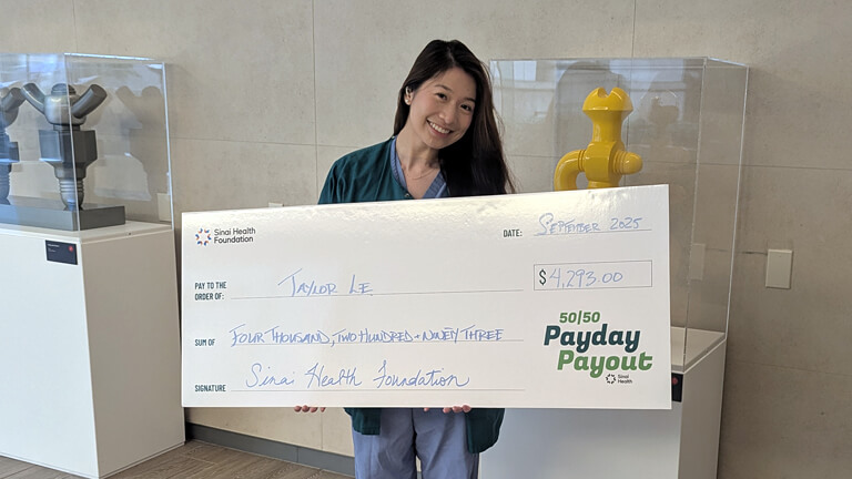 Taylor Le, August 27 2025 Payday Payout winner holding cheque.