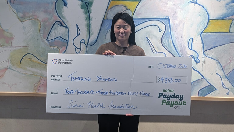 Tshering Yangdon, October 1 2025 Payday Payout winner holding cheque.