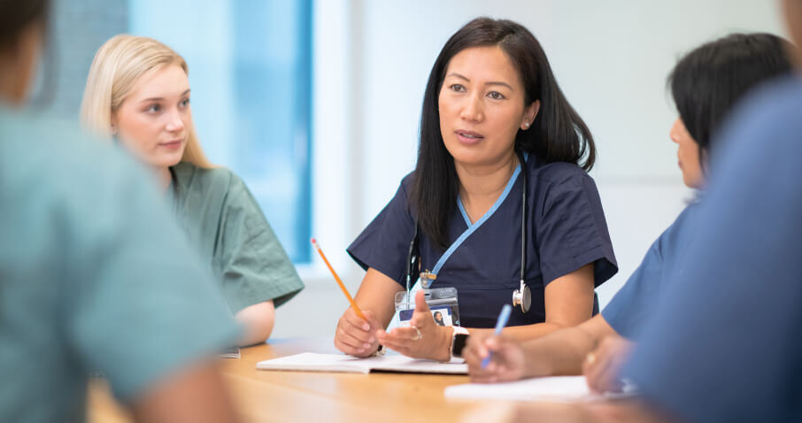 A group of nurses having a discussion at a table